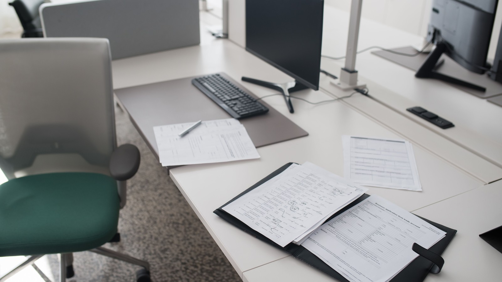 Organized documents in a binder on a desk