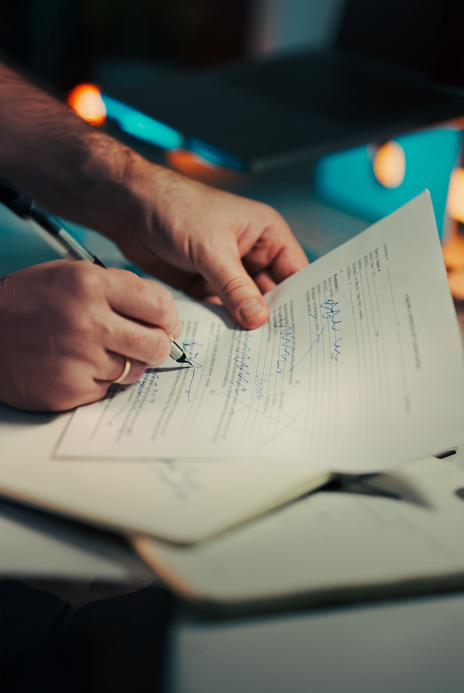 Hands reviewing and signing a business agreement