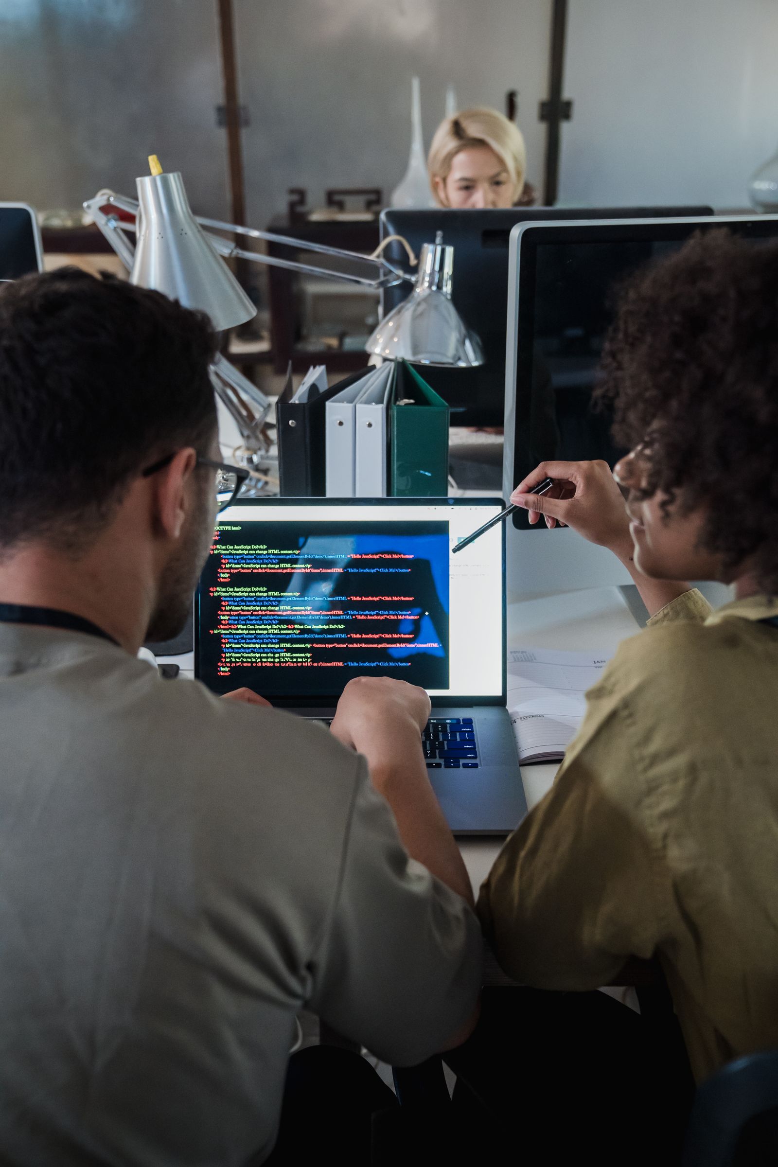 Technical colleagues discussing software documentation