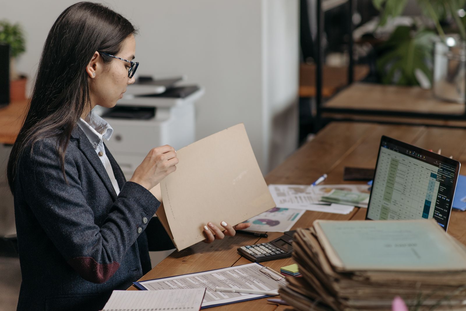 Professional holding a document folder at a desk