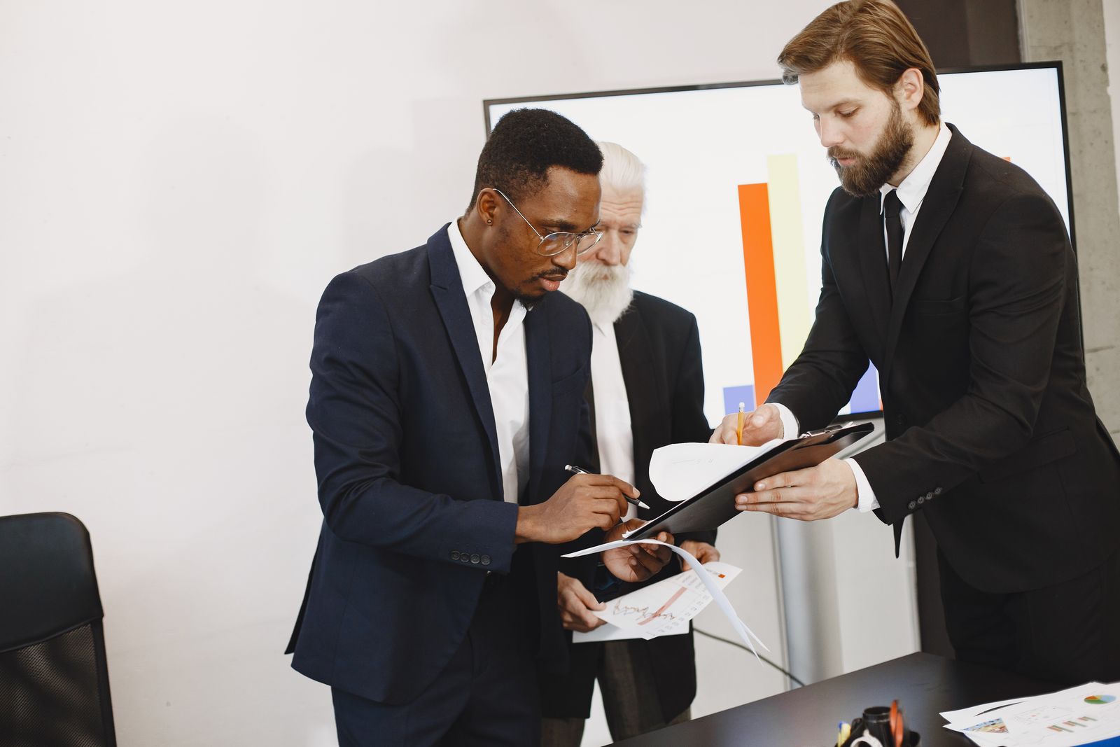Business team reviewing and signing documents