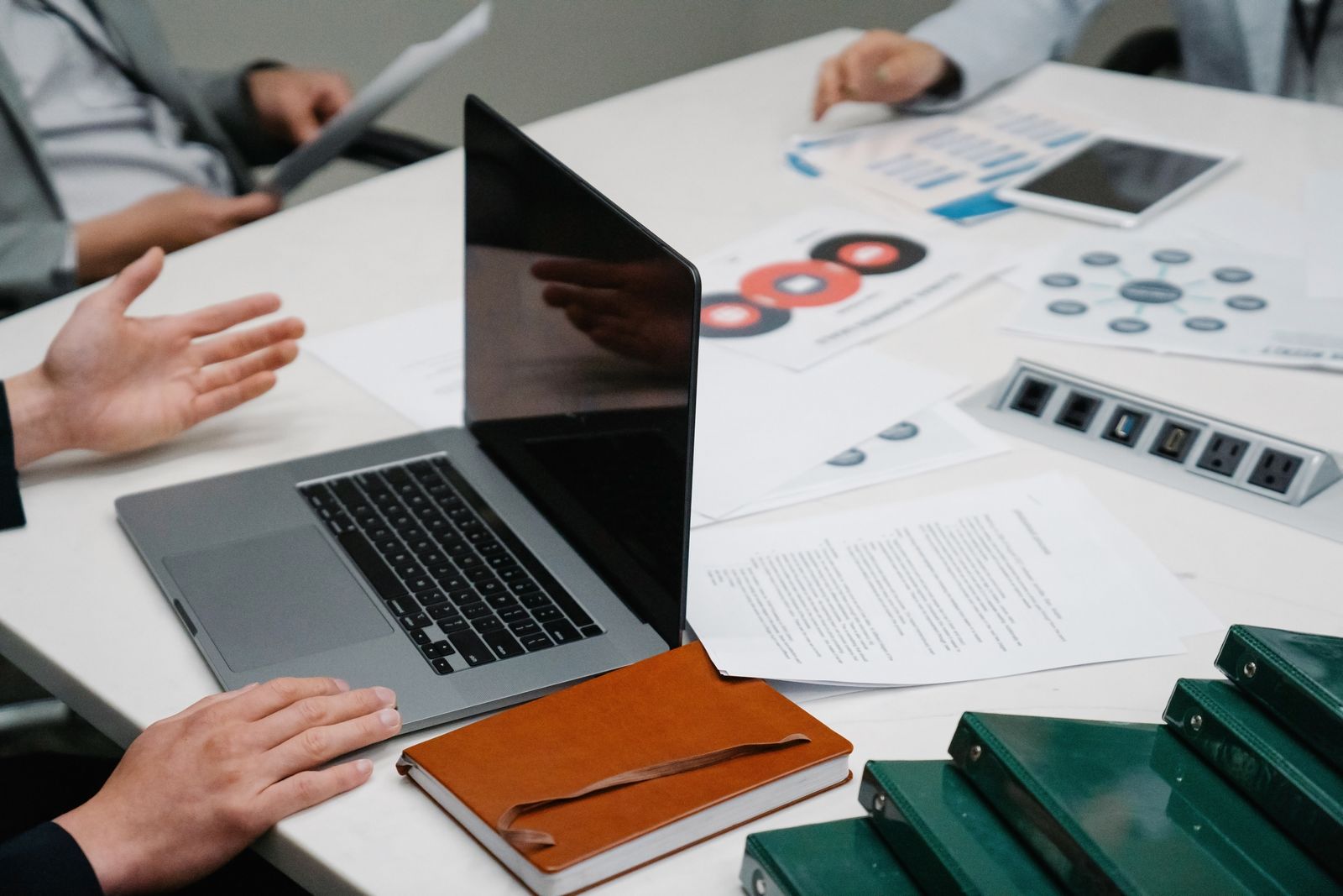 Business documents and laptop during a meeting
