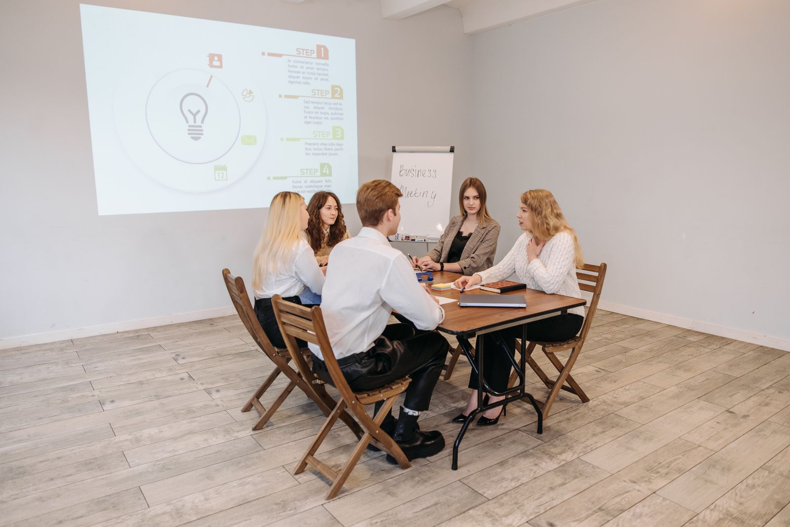 Team gathered around a table for a presentation