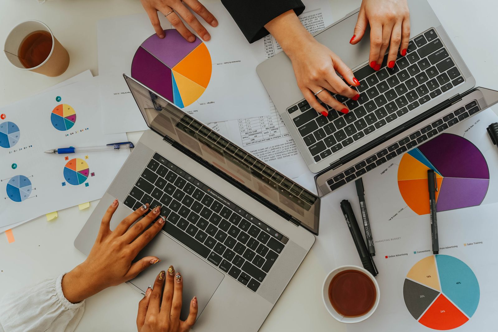 Team working with laptops and reports