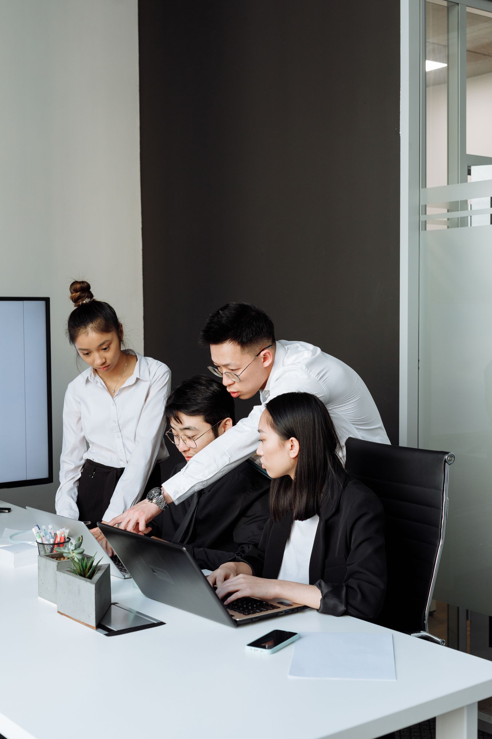 Professionals discussing material on a laptop
