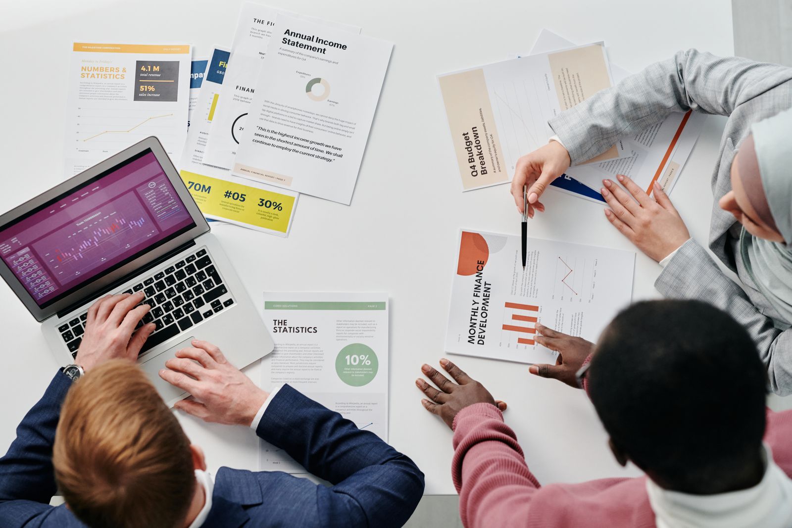 Private equity team reviewing financial models and investment documents