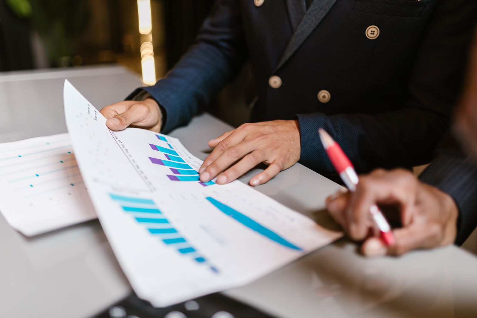 Investment team analysing portfolio performance and financial reports