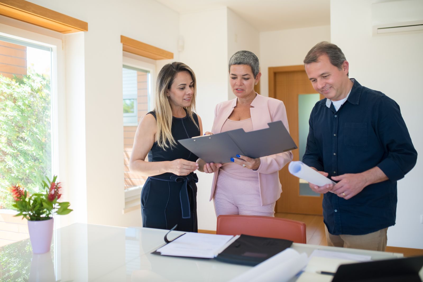 Commercial real estate team reviewing property transaction documents