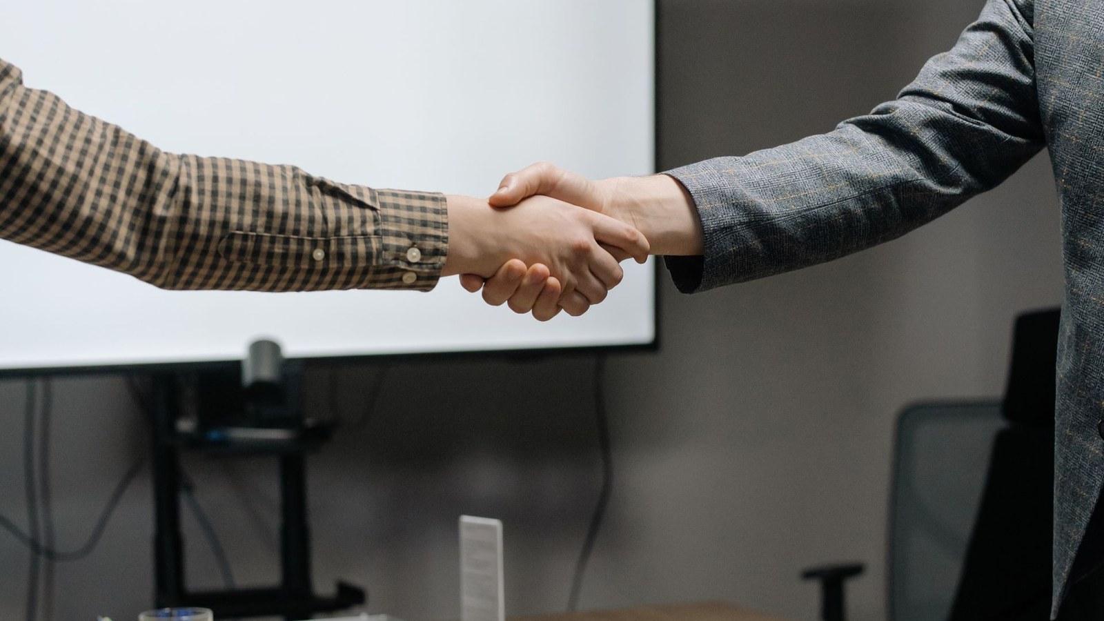 Deal professionals completing a transaction discussion